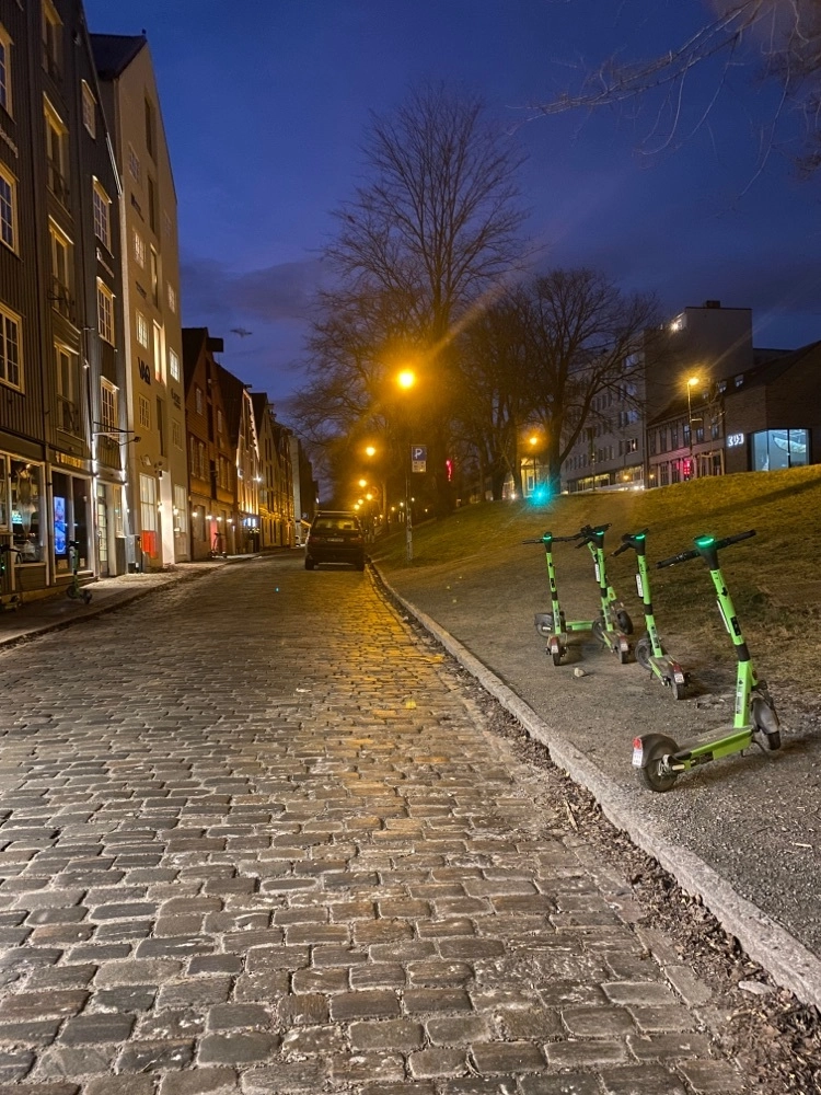 Electric scooters parked along the road in downtown Trondheim – a typical scene during urban caching in the city.