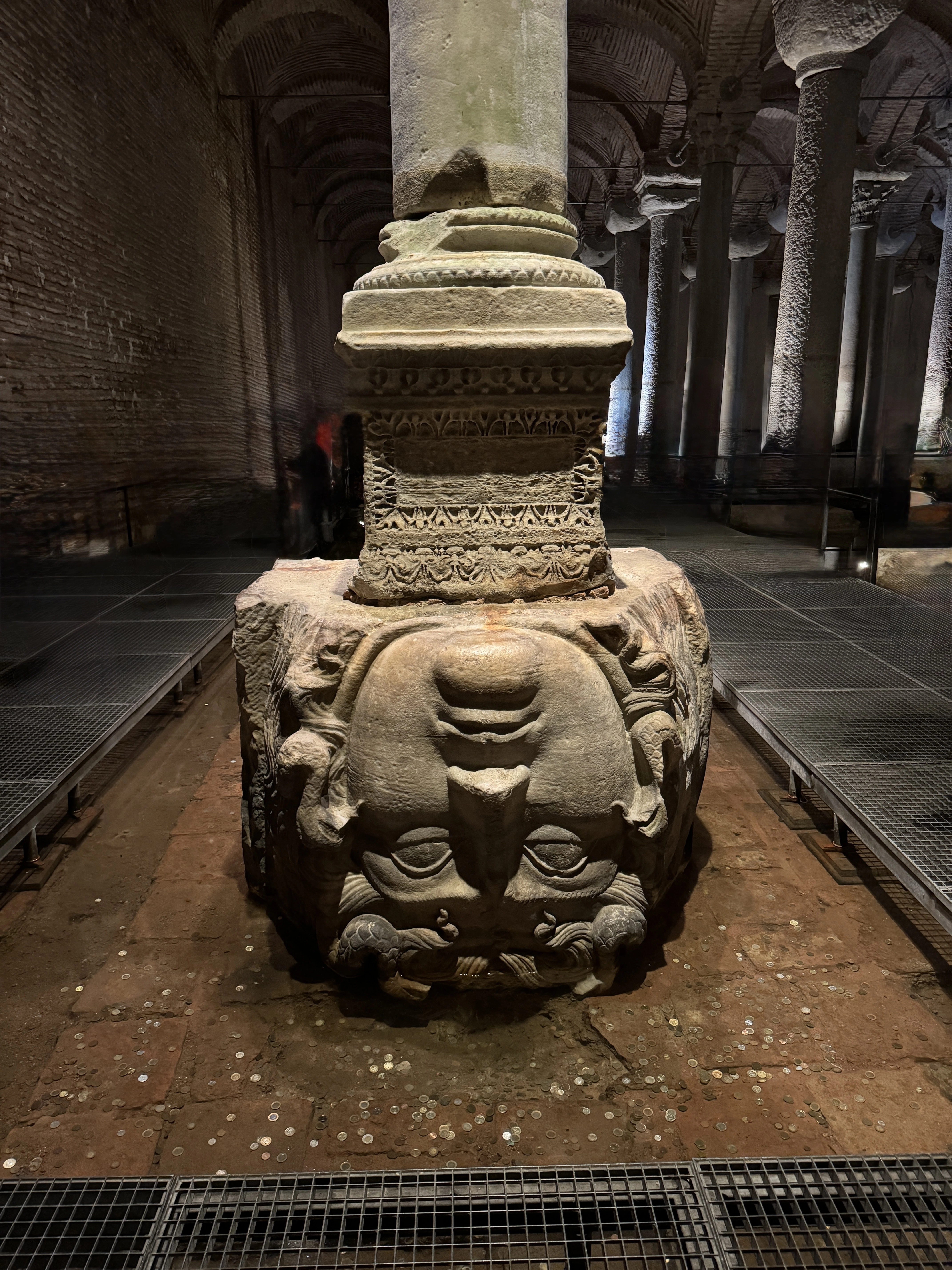 Ancient Medusa head carved into the base of a column at Basilica Cistern