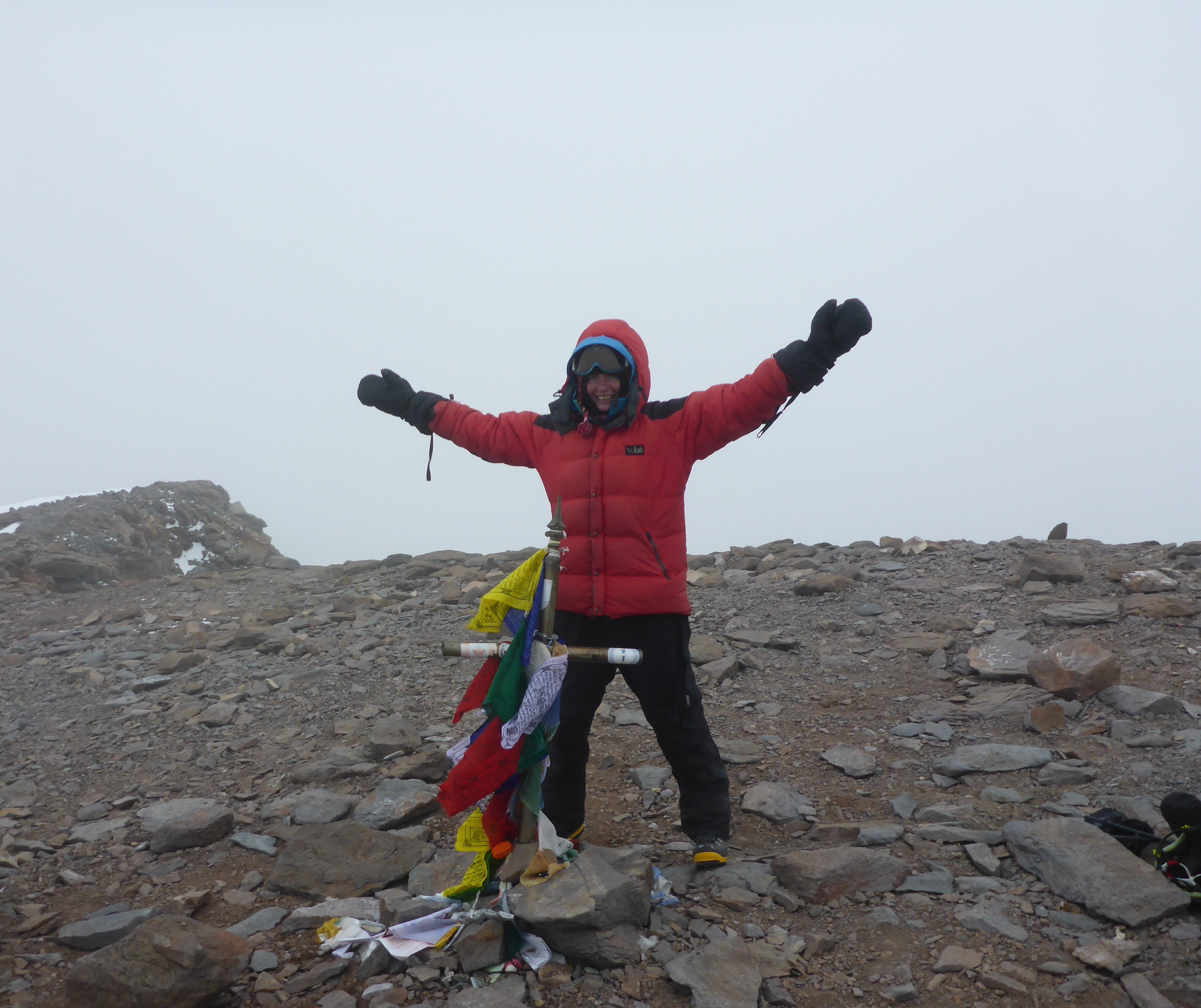 Hege at the summit of Aconcagua in thick grey weather. No view, but a big smile after reaching the top and logging the world’s highest geocache.