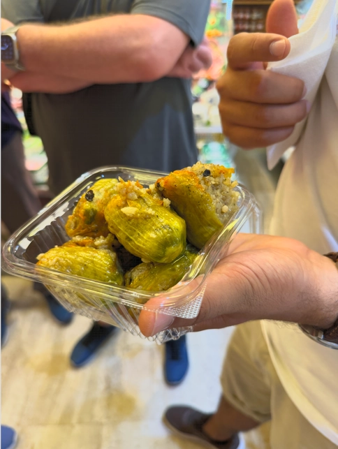 Close-up of dolma stuffed with rice and herbs, wrapped in grape leaves