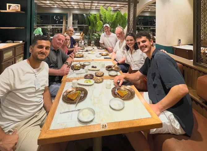A group of people seated around a restaurant table in Istanbul, ready to enjoy traditional Turkish cuisine